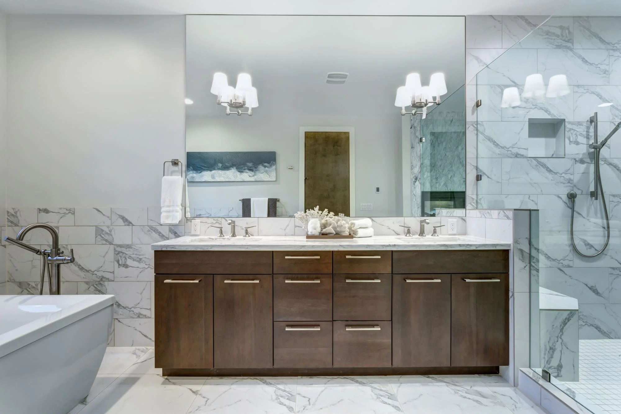 Custom mirrors Chicago example: a large frameless mirror spanning a double vanity in a marble bathroom