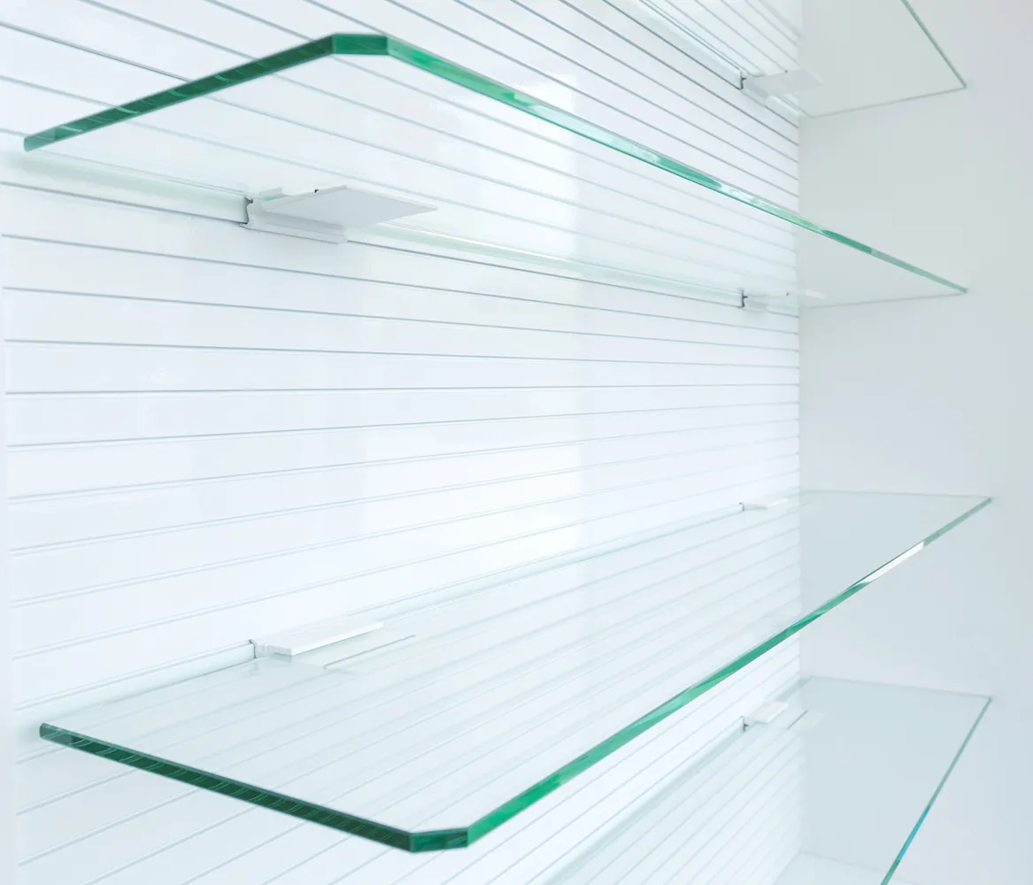 Clear custom glass shelves Chicago homeowners order, with clipped corners and polished edges on wall brackets
